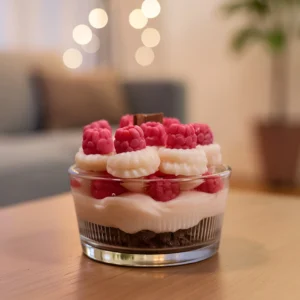 dessert kerze Cremiges Schichtdessert mit frischen Himbeeren, Sahne und Schokoladenboden in Glasschale auf Holztisch, Bokeh-Lichterketten im Hintergrund